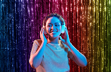 Image showing woman in headphones listening to music at party