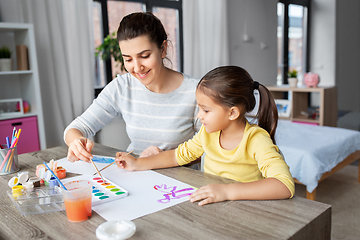 Image showing mother with little daughter drawing at home