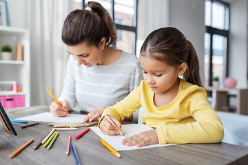 Image showing mother with little daughter drawing at home