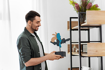 Image showing man decorating home with art in frame