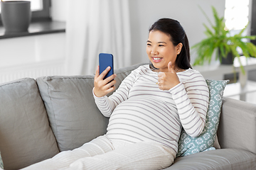 Image showing happy pregnant woman having video call on phone