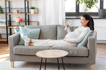 Image showing pregnant woman with water in glass bottle at home