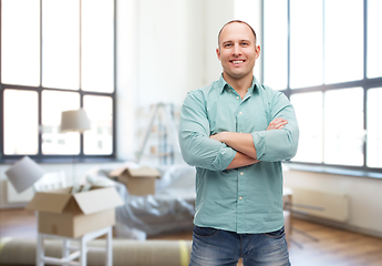 Image showing smiling man with crossed arms at new home