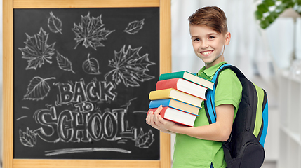 Image showing happy student boy with school bag and books