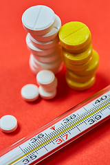 Image showing Mercury thermometer and medical pills on background