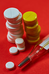 Image showing Mercury thermometer and medical pills on background