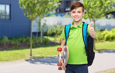 Image showing boy with backpack and skateboard showing thumbs up