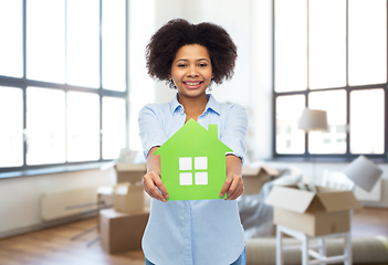 Image showing african woman with green house icon at new home