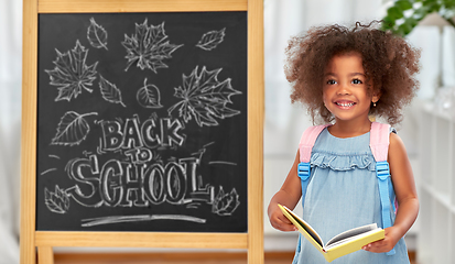 Image showing little african student girl with book and backpack