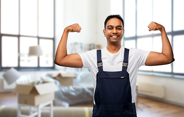 Image showing smiling indian worker showing power at new home