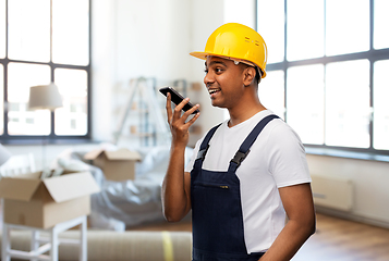 Image showing indian worker recording voice on phone at new home