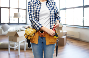 Image showing woman with working tools on belt at new home