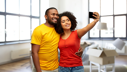 Image showing african american couple taking selfie at new home