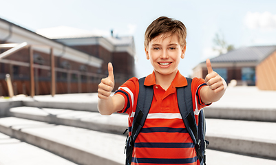 Image showing happy student boy with backpack showing thumbs up