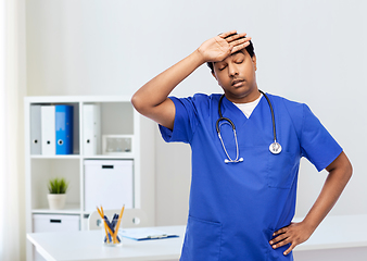 Image showing stressed doctor or male nurse in blue uniform