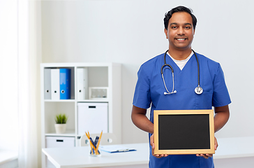 Image showing happy indian male doctor or nurse with chalkboard