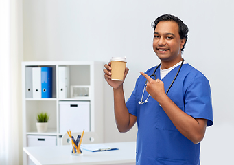 Image showing male doctor with stethoscope drinking coffee