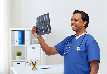 Image showing happy indian doctor or male nurse with x-ray