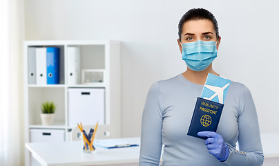 Image showing young woman in mask with air ticket and passport