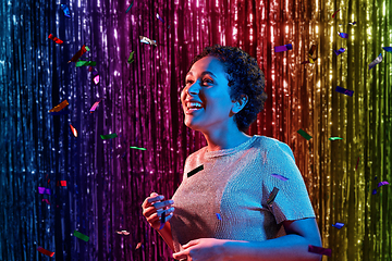 Image showing african woman under confetti at nightclub party