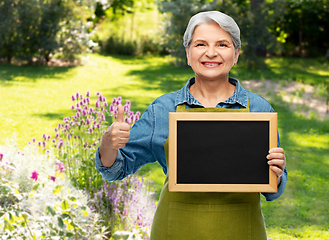 Image showing senior gardener with chalkboard showing thumbs up