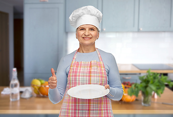 Image showing smiling senior woman or chef holding empty plate