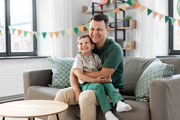 Image showing happy father and little son at home birthday party