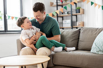 Image showing happy father and little son at home birthday party