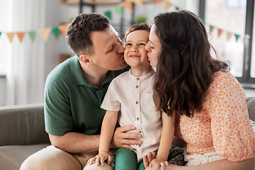 Image showing happy parents kissing little son at birthday party