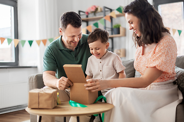 Image showing happy family opening birthday presents at home