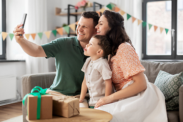 Image showing happy family taking selfie on birthday at home