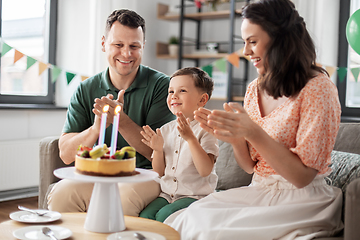 Image showing happy family with birthday cake at home