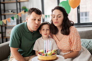 Image showing happy family with birthday cake at home