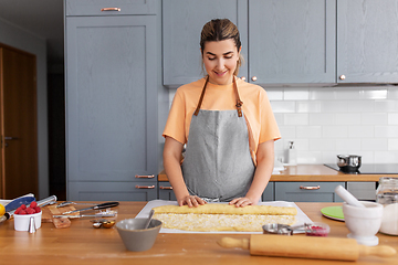 Image showing woman cooking food and baking buns at home kitchen