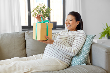 Image showing happy pregnant woman with gift box at home