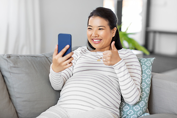 Image showing happy pregnant woman having video call on phone