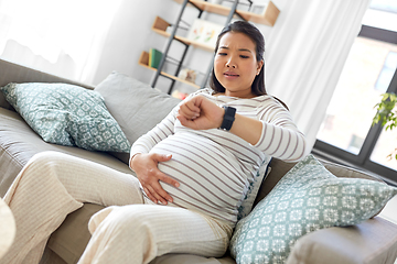 Image showing pregnant woman having labor contractions at home