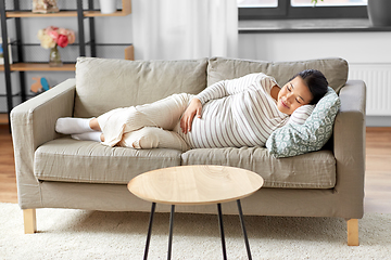 Image showing pregnant asian woman sleeping on sofa at home