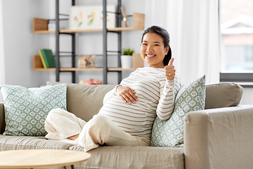 Image showing happy pregnant asian woman showing thumbs up