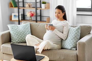 Image showing pregnant asian woman with laptop at home