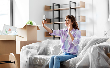 Image showing woman having video call and moving into new home