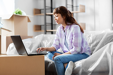 Image showing woman with laptop moving into new home