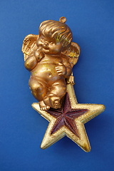 Image showing little angel on golden star
