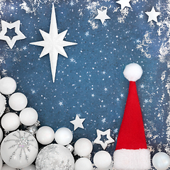 Image showing Christmas Eve Background with Santa Hat and Tree Baubles 