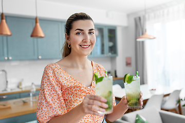 Image showing woman with lime mojito cocktail at home kitchen