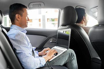 Image showing male passenger with laptop computer in taxi car