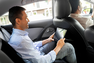 Image showing male passenger with tablet computer in taxi car