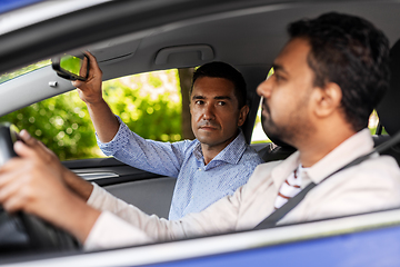 Image showing car driving school instructor teaching male driver