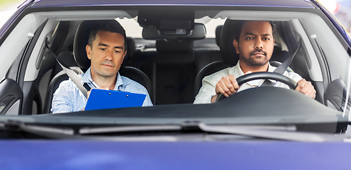 Image showing car driving school instructor and young driver