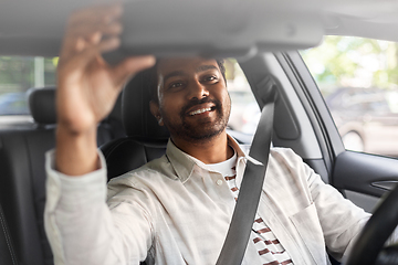 Image showing smiling indian man or driver driving car